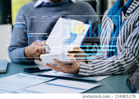 Businessman hand Project manager working and update tasks and Gantt chart scheduling virtual diagram 134965276