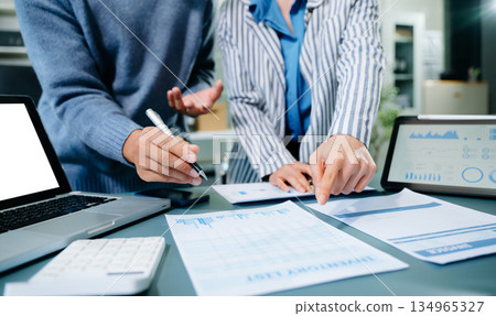 Two young businesswomen working new start up project Laptop computer and digital tablet and smart phone and discussing business plan. At office Two young businesswomen working new start up project Laptop computer and digital tablet and smart phone and discussing business plan. At office 134965327
