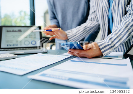Team business meeting presentation. Hand businessman working project in modern office.Laptop computer and tablet and smart phone on white desk 134965332