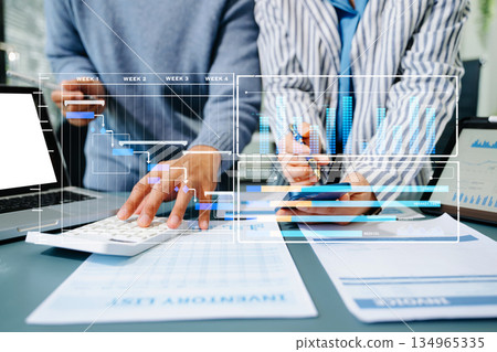 Project manager working and update tasks with milestones progress planning and Gantt chart scheduling diagram. business working with smart phone, tablet 134965335