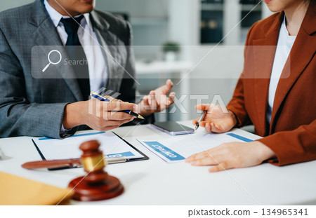 Concept with blank search bar.justice and law concept.team judge in a courtroom with the gavel,working with digital tablet computer. Concept with blank search bar.justice and law concept.team judge in a courtroom with the gavel,working with digital tablet computer. 134965341