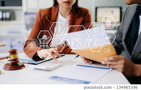 Digital law and justice concept with holographic icons, gavel, and scales in modern office, symbolizing innovation, legal technology 134965396