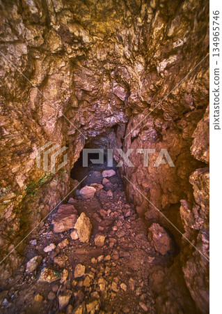 Abandoned Mine Tunnel Interior with Rocky Walls and Debris in Nevada Abandoned Mine Tunnel Interior with Rocky Walls and Debris in Nevada 134965746