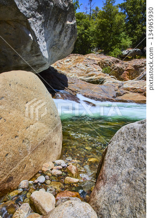 Granite Boulders Crystal Clear River and Lush Forest in Sunlit Wilderness Granite Boulders Crystal Clear River and Lush Forest in Sunlit Wilderness 134965930