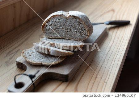Window light and homemade sourdough bread: a tranquil breakfast scene 134966107