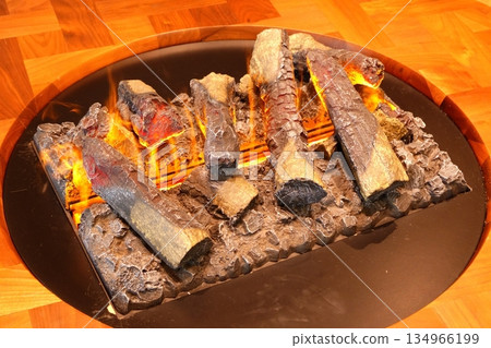 A table with a flickering artificial bonfire A table with a flickering artificial bonfire 134966199