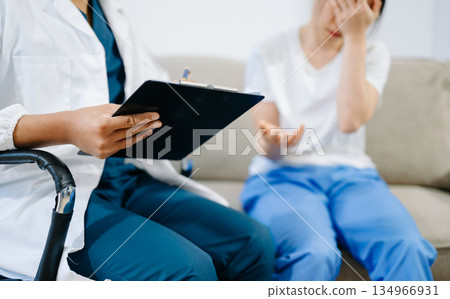 Doctor comforting patient with pain and stress during consultation, showing healthcare, empathy, support, and professional medical care. Doctor comforting patient with pain and stress during consultation, showing healthcare, empathy, support, and professional medical care. 134966931