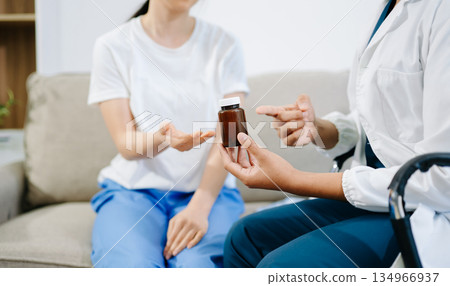 Healthcare professional discussing medication with patient during consultation, showing trust, care, Healthcare professional discussing medication with patient during consultation, showing trust, care, 134966937
