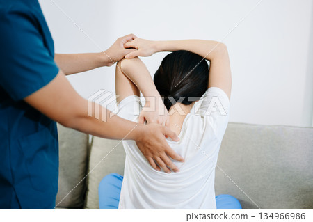 Healthcare professional providing back physiotherapy and pain relief treatment, showing patient recovery, rehabilitation, and physical therapy care support. Healthcare professional providing back physiotherapy and pain relief treatment, showing patient recovery, rehabilitation, and physical therapy care support. 134966986