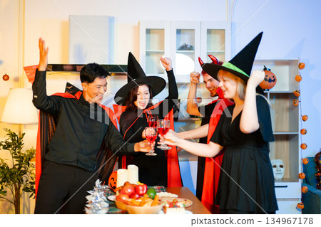 Halloween party react with surprise and laughter to spooky props like pumpkins and a ghost skeleton. Perfect seasonal fun, decor, and festive vibes. Halloween party react with surprise and laughter to spooky props like pumpkins and a ghost skeleton. Perfect seasonal fun, decor, and festive vibes. 134967178