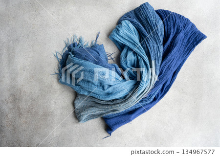 Soft textile scarf on the concrete background Soft textile scarf on the concrete background 134967577