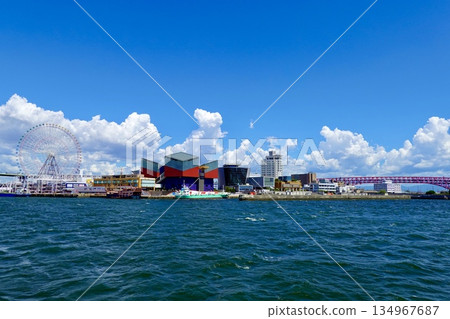 A view of the Ferris wheel, Osaka Aquarium Kaiyukan, and Minato Bridge from offshore Osaka Port at the mouth of the Aji River. Minato Ward, Osaka City A view of the Ferris wheel, Osaka Aquarium Kaiyukan, and Minato Bridge from offshore Osaka Port at the mouth of the Aji River. Minato Ward, Osaka City 134967687