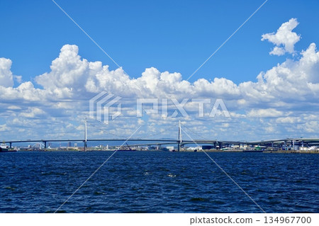 A view of the Konohana Bridge spanning Maishima on the left and Kitako on the right from off the coast of Osaka Port. Konohana Ward, Osaka City A view of the Konohana Bridge spanning Maishima on the left and Kitako on the right from off the coast of Osaka Port. Konohana Ward, Osaka City 134967700