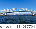 A view of Osaka Port and the red Minato Bridge across the white Yumemai Bridge, Konohana Ward, Osaka City 134967704