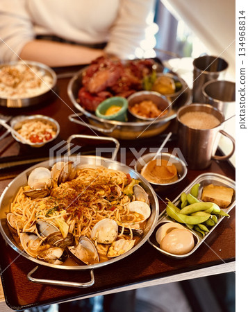 Seafood spaghetti with clams served in a metal pan Seafood spaghetti with clams served in a metal pan 134968814