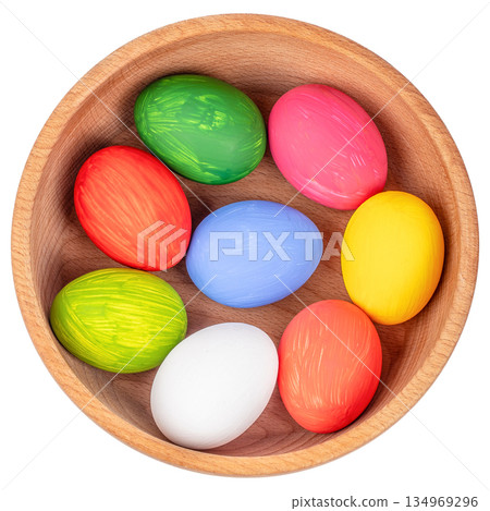 Colorful painted Easter eggs in wooden bowl isolated on white background top view 134969296