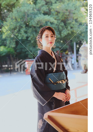 A woman in a furisode kimono visiting a shrine | Prayers, Traditions, and Japanese Culture A woman in a furisode kimono visiting a shrine | Prayers, Traditions, and Japanese Culture 134969320