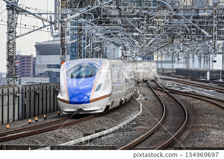 Joetsu-Hokuriku Shinkansen E7 departing from the platform 134969697