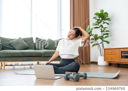Young Asian woman stretching yoga workout on exercise mat Young Asian woman stretching yoga workout on exercise mat 134969768