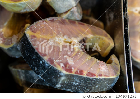 Frozen Salmon Fillets With Skins, Ice Crystals, and Bright Orange Flesh Texture Frozen Salmon Fillets With Skins, Ice Crystals, and Bright Orange Flesh Texture 134971255