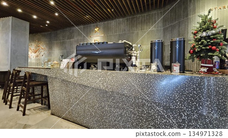 A sleek Starbucks Reserve counter with espresso machines, and holiday merchandise blends premium coffee culture 134971328
