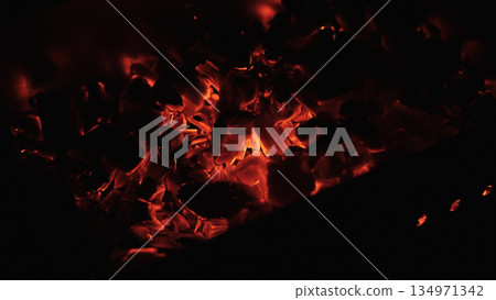 closeup of hot charcoal in dark environment closeup of hot charcoal in dark environment 134971342