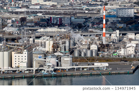 Fuji City's heavy industry waterfront, lined with chimneys and tanks 134971945