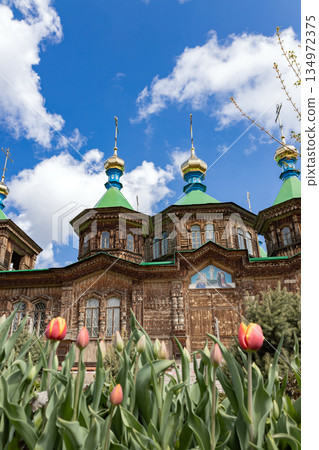 Old wooden church with green roofs and golden domes 134972375
