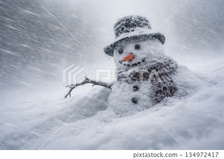 Classic Snowman With Top Hat And Knit Scarf During Heavy Winter Blizzard On Snow Hill 134972417