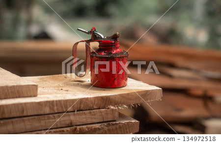 Oil Can Rusty On a Timber Plank Oil Can Rusty On a Timber Plank 134972518