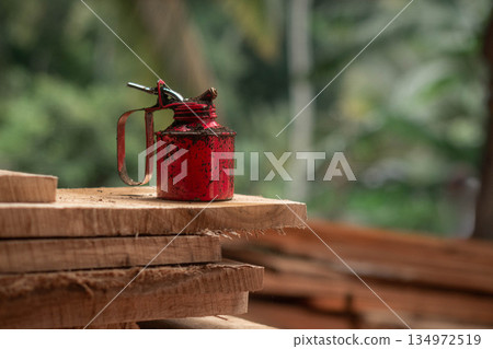 Oil Can Rusty On a Timber Plank Oil Can Rusty On a Timber Plank 134972519