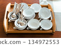 Stack of White Soup Bowls and Spoons 134972553