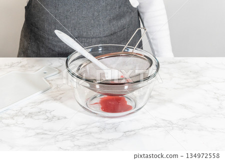 Easter Cookie Sandwiches decorated in green and yellow with raspberry buttercream, styled for spring dessert content. Great for holiday campaigns and food styling. 134972558