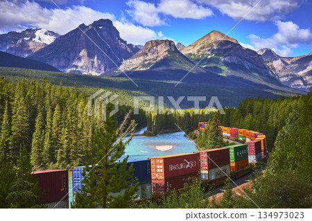 Freight Train Winding Along Morant's Curve With Blue River And Rocky Mountains Freight Train Winding Along Morant's Curve With Blue River And Rocky Mountains 134973023