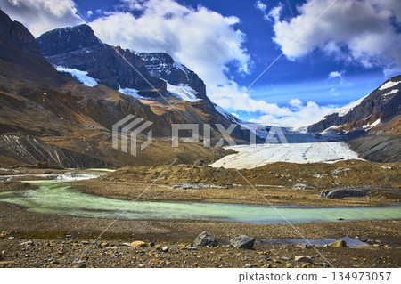 Athabasca Glacier Meltwater Stream and Rugged Mountain Peaks in Jasper Canada Athabasca Glacier Meltwater Stream and Rugged Mountain Peaks in Jasper Canada 134973057