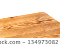 A wooden table corner or tabletop separated from a white background. 134973082