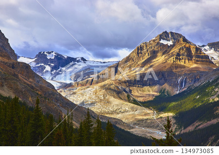 Mountain Glacier River Valley with Dramatic Clouds and Sunlight in Rugged Wilderness Mountain Glacier River Valley with Dramatic Clouds and Sunlight in Rugged Wilderness 134973085