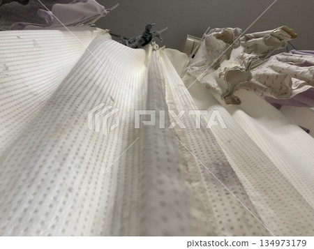 Black mold and stains on the curtains that have risen to the surface Black mold and stains on the curtains that have risen to the surface 134973179