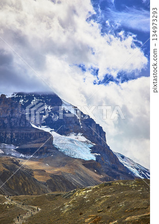 Athabasca Glacier Hikers and Majestic Mountain Under Dramatic Sky Canada 134973293