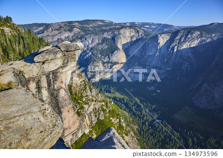 Glacier Point Granite Outcrop and Yosemite Valley Cliffs in Bright Summer Sun Glacier Point Granite Outcrop and Yosemite Valley Cliffs in Bright Summer Sun 134973596