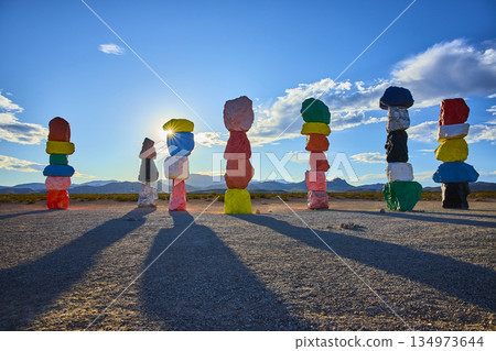 Seven Magic Mountains Colorful Rock Cairns and Sunburst in Nevada Desert 134973644