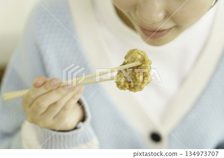 Close-up of a young Japanese woman eating fried chicken Close-up of a young Japanese woman eating fried chicken 134973707