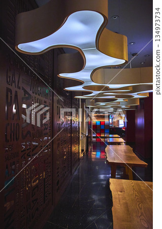 Modern Ceiling Lights Wooden Tables and Artistic Wall in Las Vegas Casino Interior Modern Ceiling Lights Wooden Tables and Artistic Wall in Las Vegas Casino Interior 134973734