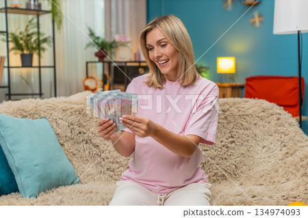 Pregnant woman counting UAH Ukrainian hryvnia cash money planning budget for childbirth financial Pregnant woman counting UAH Ukrainian hryvnia cash money planning budget for childbirth financial 134974093
