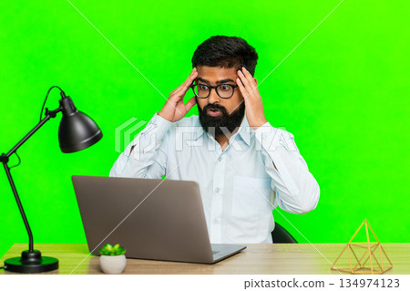 Arabian man looking at laptop with disappointment sad angry expression showing failure or bad result Arabian man looking at laptop with disappointment sad angry expression showing failure or bad result 134974123