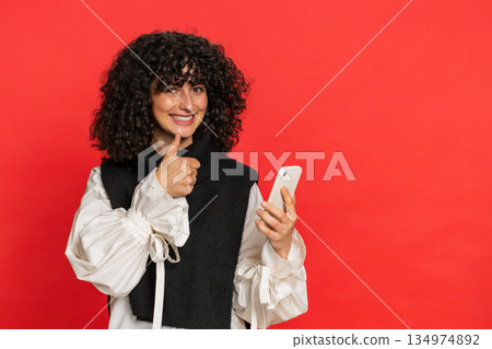 Woman using smartphone showing pointing on phone, advertising web application, positive feedback 134974892