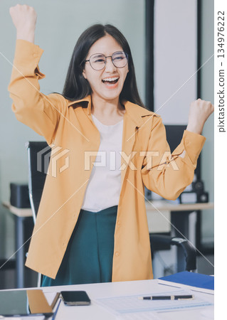 Business woman using calculator for do math finance on wooden desk in office and business working background, tax, accounting, statistics and analytic research concept. Business woman using calculator for do math finance on wooden desk in office and business working background, tax, accounting, statistics and analytic research concept. 134976222