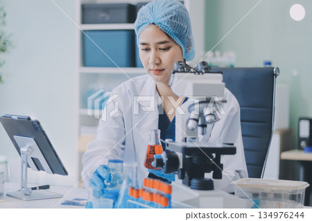 Portrait, science and happy woman on laptop in lab to research chemistry, test or innovation. Microscope, scientist and face of medical doctor in goggles for microbiology, healthcare or pharma study 134976244