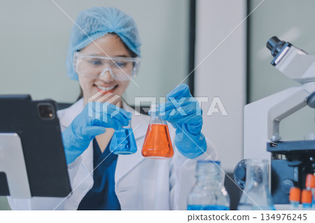 Portrait, science and happy woman on laptop in lab to research chemistry, test or innovation. Microscope, scientist and face of medical doctor in goggles for microbiology, healthcare or pharma study 134976245