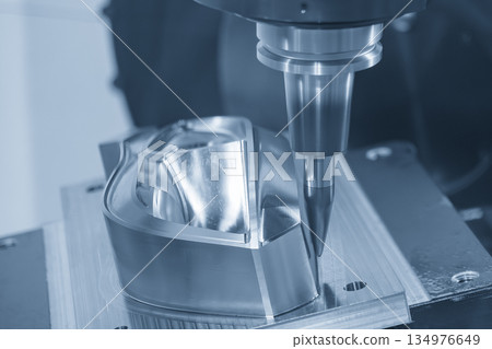 The CNC milling machine finish cut the mold parts by solid barrel tool in the blue tone scene. 134976649